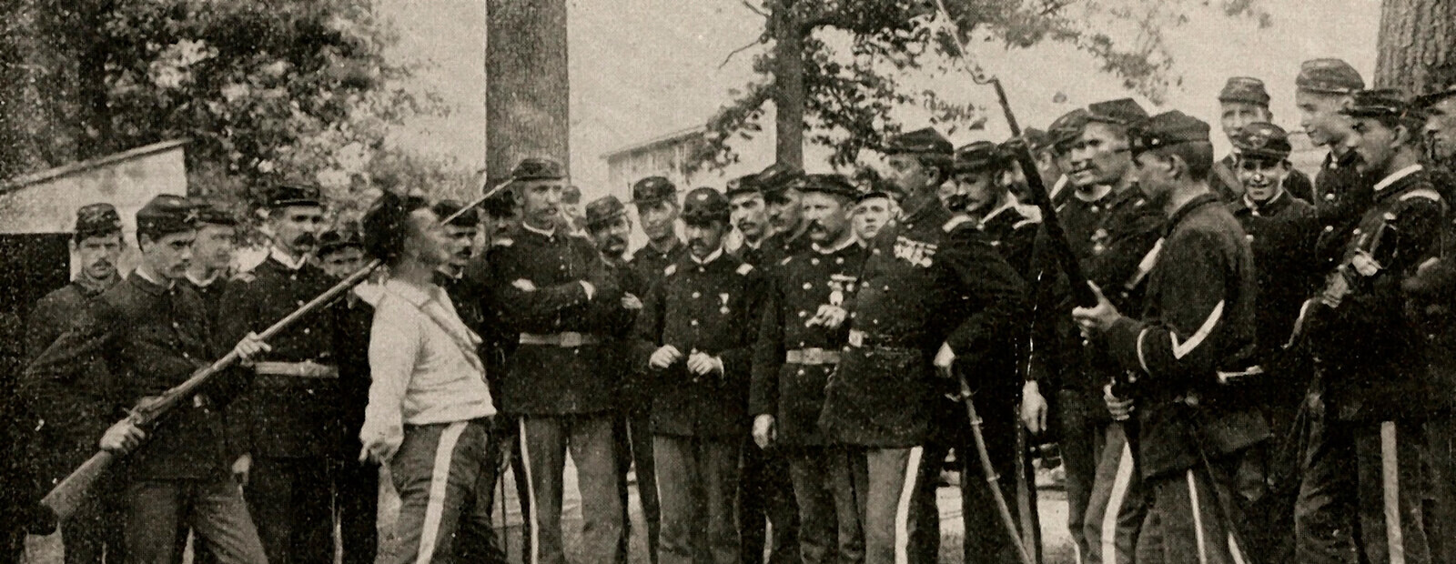 Private William L. Iams in a collarless white shirt stands among the assembled Tenth Regiment at Camp Sam Black, Homestead, 23 July 1892